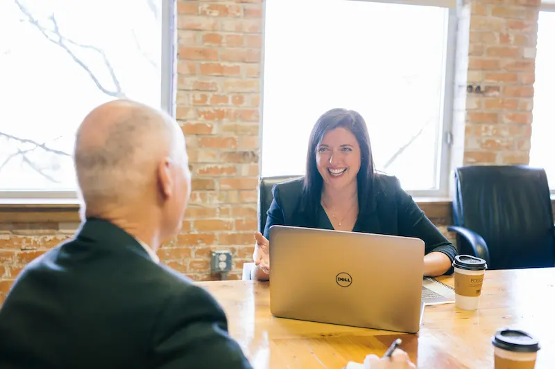 A Father and Daughter discuss business matters at a conference room table